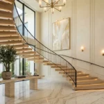 Modern luxury staircase with warm under-step lighting, elegant wall molding, abstract art, and indoor greenery decor.